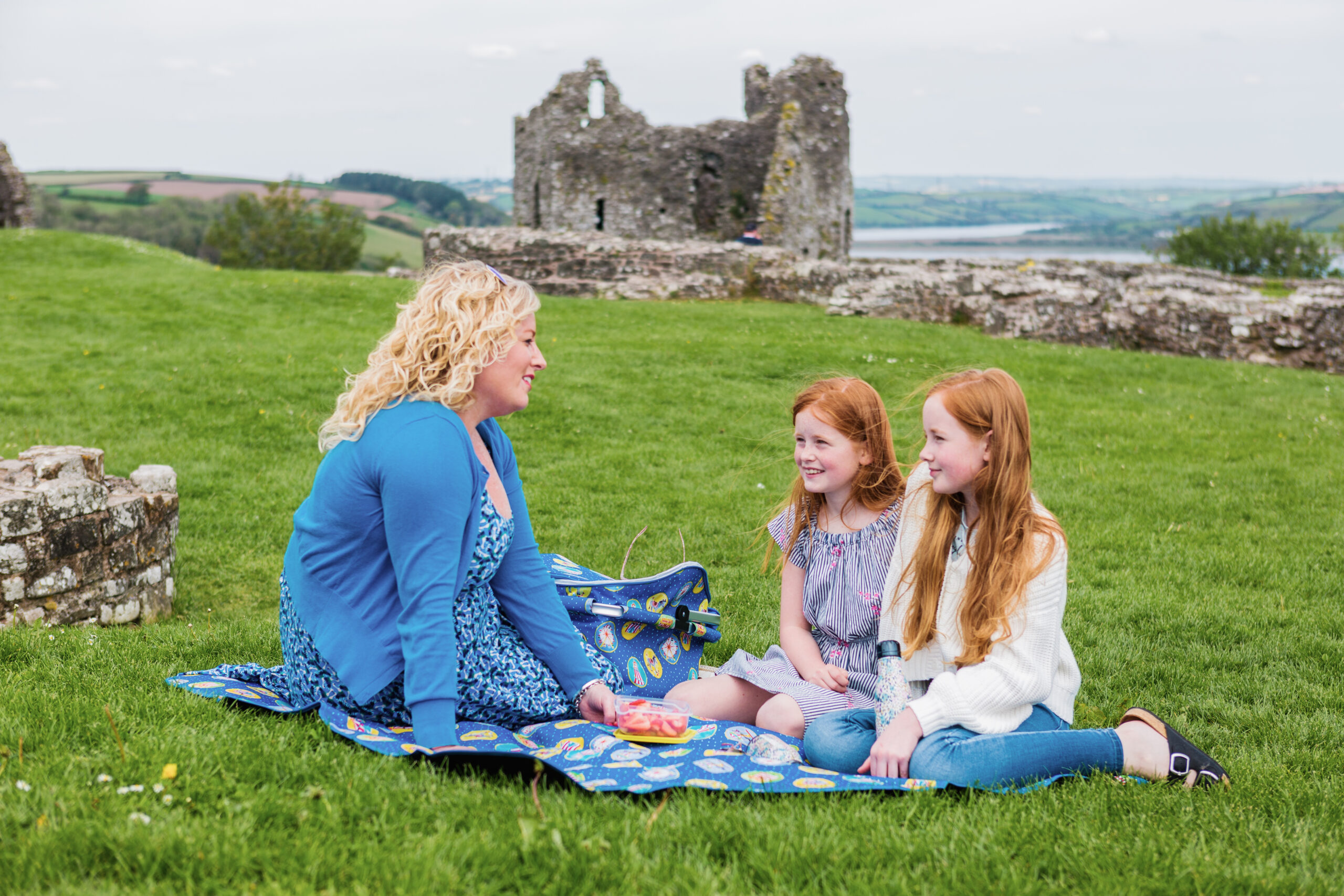 Mum and two girls having a picnic