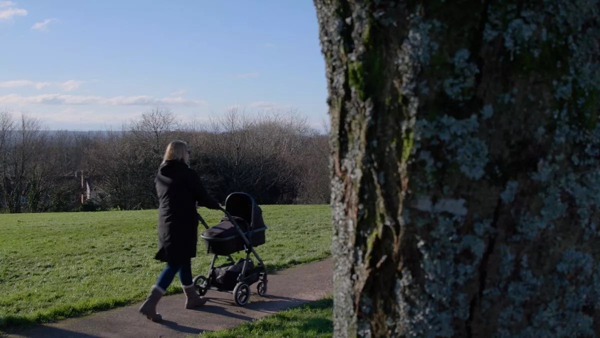 Foster carer pushing pram